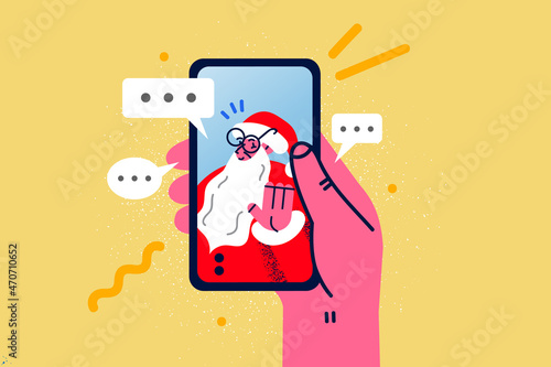 Person talk on video call with Santa on cellphone 