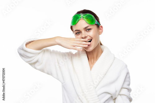 cheerful woman in a white robe facial care rejuvenation lifting