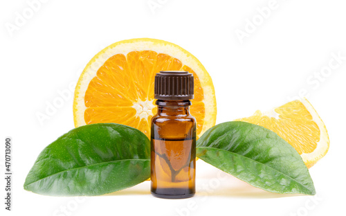 Natural organic Orange essential oil in a glass bottle isolated on a white background.Fresh Orange fruits with green leaves. Extract of orange oil.Vitamins food.Ripe oranges.Selected focus.