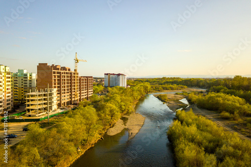 Aerial view of tall residential apartment buildings under construction and Bystrytsia river in Ivano-Frankivsk city, Ukraine photo