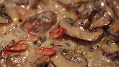 10 second slow motion video of how to bake mushrooms in sauce with chili pepper