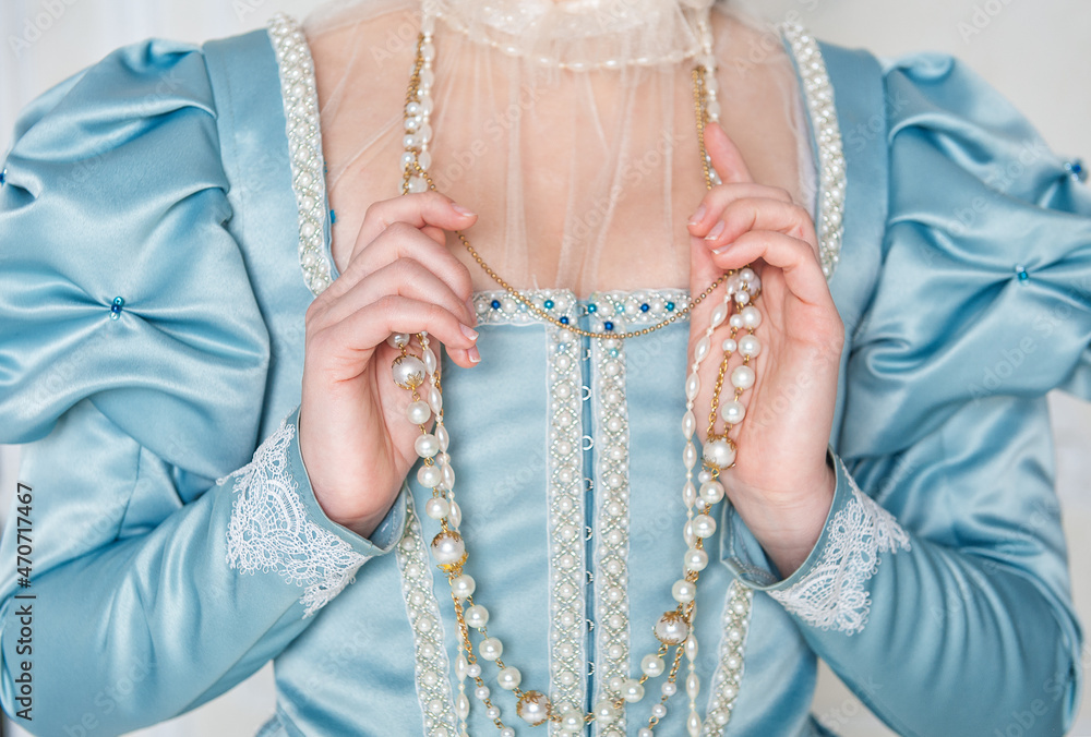 Hands of woman in beautiful medieval dress holding beads Hands of woman in beautiful medieval dress holding beads