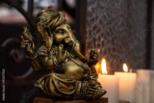 Statue of Lord ganesha figure , Indian ganesh festival with warm candle light. 