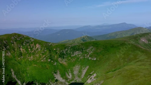 Aerial View of the highest lake of Carpathian Mountains - Brebenescul, location between peaks Brebenescul and Hutyn Tomnatyk. Tourist places of Ukraine. Clear summer day. Concepts of tourism photo