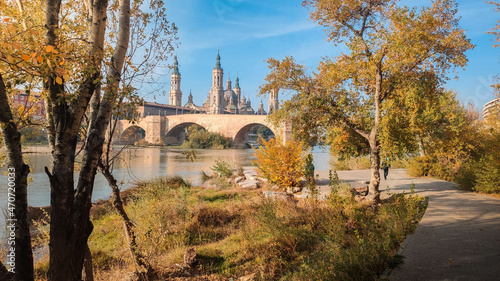 Photograph of autumn in Zaragoza  with the trees full of orange and yellow colors and a beautiful blue sky. Aragon. Spain.