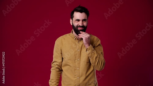 No! this is not at all what is needed, I don't like it, the guy is indignant at the camera, he doesn't like it, he is bearded, black-haired, dressed in a brown shirt, the background is red