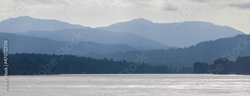 Distant mountains and lake in British Columbia. A view of a valley filled by a sea and with various layers of mountains