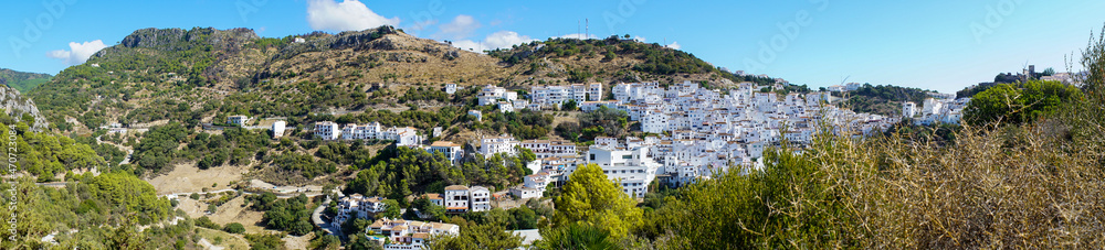 Typical spanish mountain village with its narrow white buildings in Andalusia in summertime