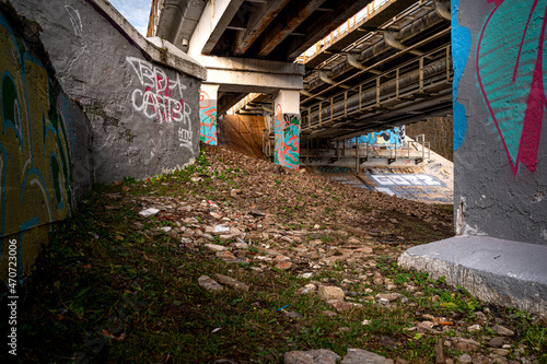piles of a railway bridge covered with graffiti
