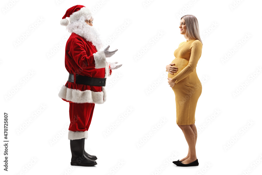 Full length profile shot of santa claus talking to a pregnant woman