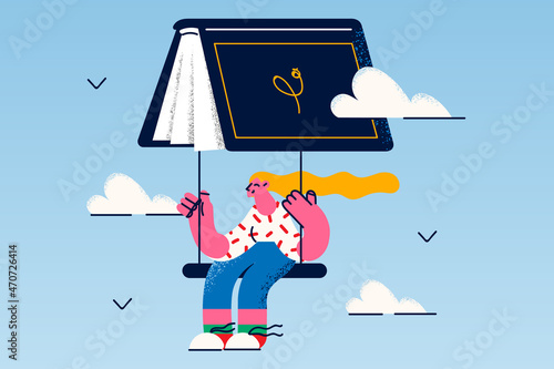 Happy girl reader fry on book as parachute