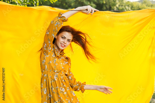 smiling woman in yellow dress posing nature yellow cloth