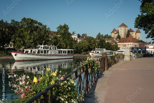 Принти на полотні Flower-filled promenade along the canals of Annecy with the castle in the backgr