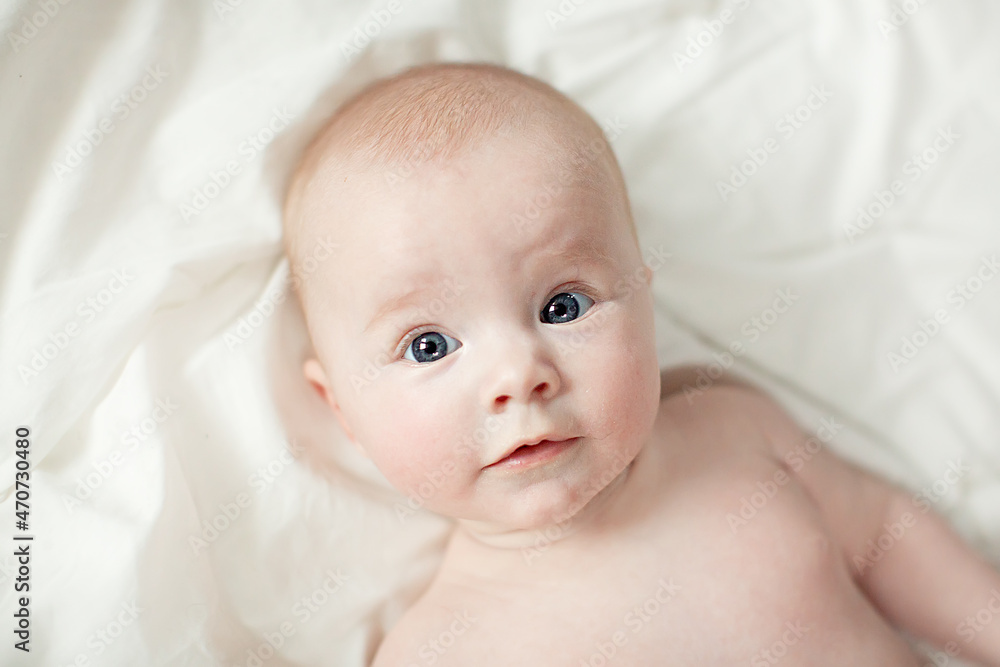 newborn baby girl in pink knitted hat on a bed newborn baby girl in pink knitted hat on a bed