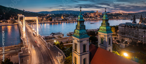 Budapest, Hungary - Aerial panoramic view of Budapest at dusk. This view includes Inner-City Mother Church of Our Lady of the Assumption, Elisabeth Bridge and Buda Castle Royal Palace at background