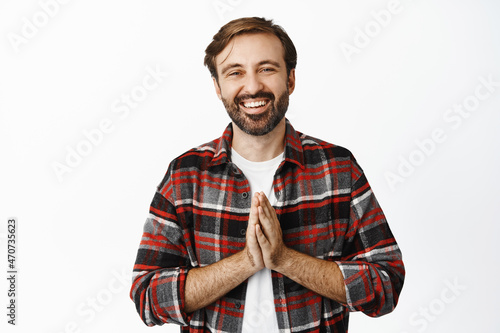 Smiling happy adult man say thank you, shows namaste appreciation gesture, expresses gratitude, standing over white background