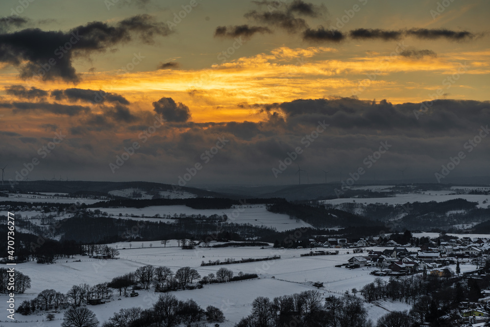Dramatic sunset in the snow covered landscape on Nideggen, Eifel, Germany