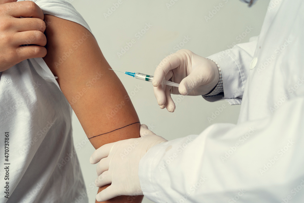 Injection vaccination against the epidemic, in the clinic. Doctor of Medical Sciences professor vaccination against the virus. Injection vaccination against the epidemic, in the clinic. Doctor of Medical Sciences professor vaccination against the virus.