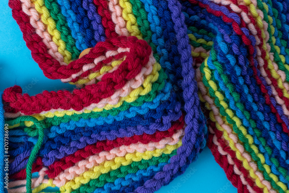 hand knitting background featuring rainbow coloured super chunky yarn 