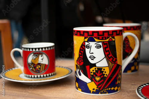 turkish coffee cups with playing cards symbol. There is kings and noblewomen picture on them.  photo