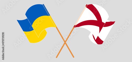 Crossed and waving flags of Ukraine and The State of Alabama