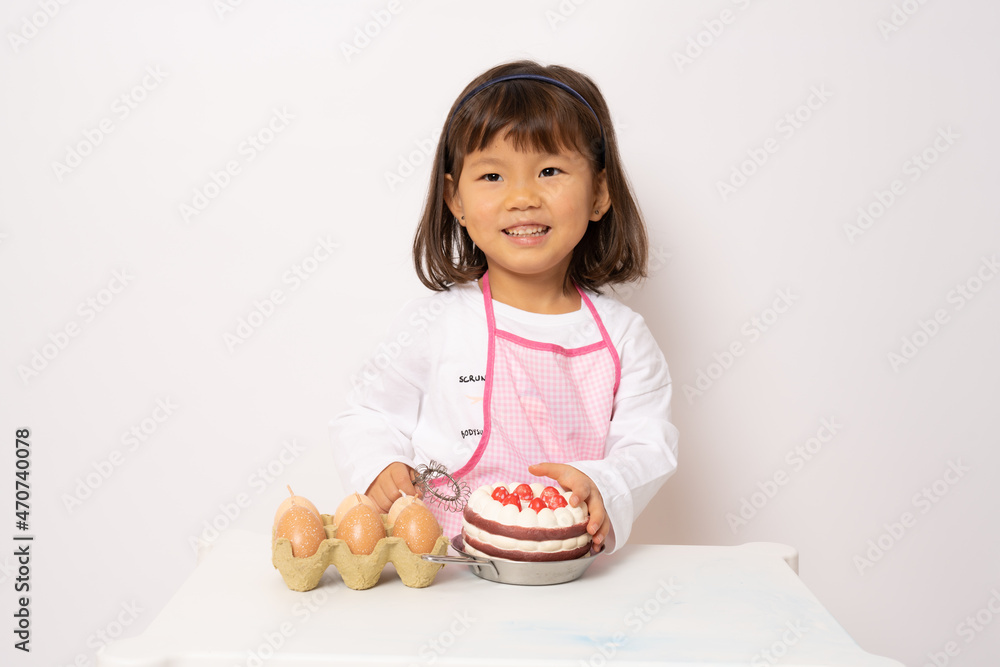 Beautiful little asian girl cooking isolate on white background Beautiful little asian girl cooking isolate on white background