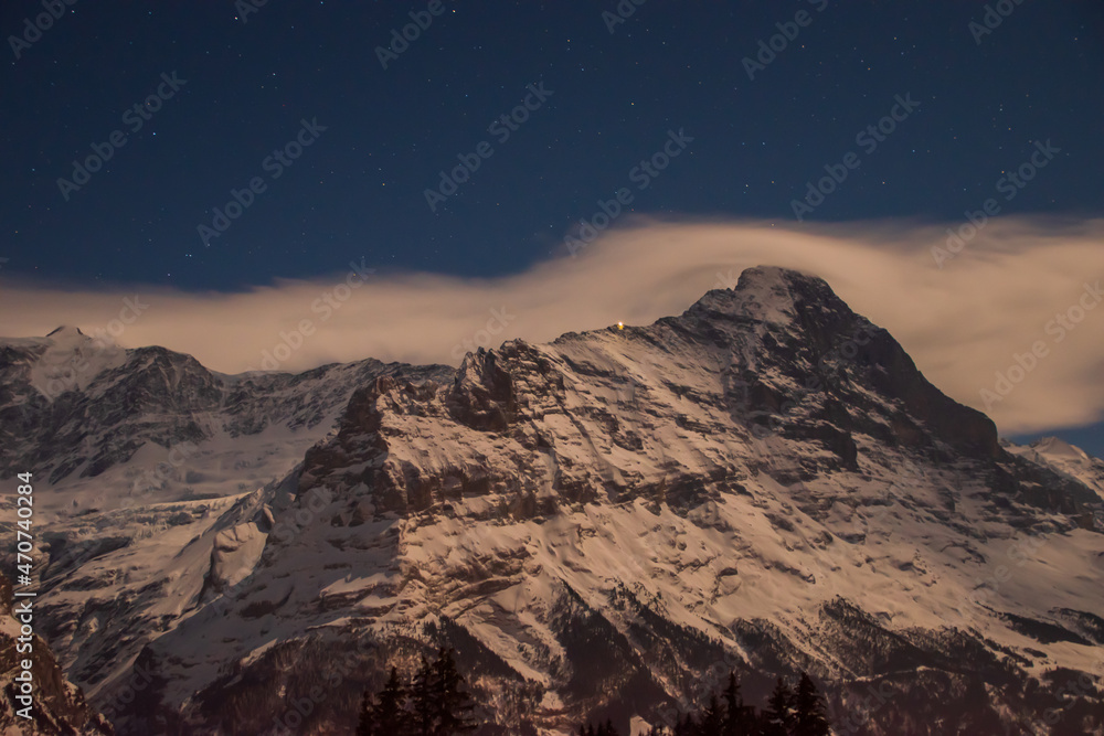 Beautiful night panoramic view of snow-capped mountains in the Swiss Alps..