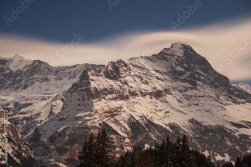 Beautiful night panoramic view of snow-capped mountains in the Swiss Alps..