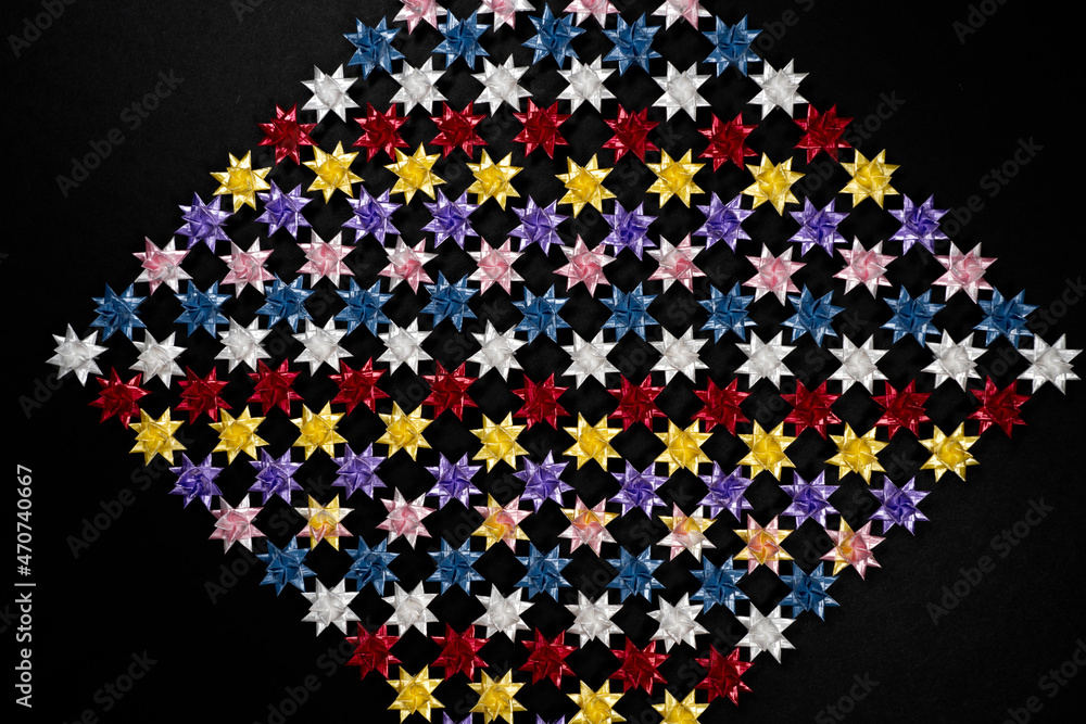 Folding paper stars on Black background.