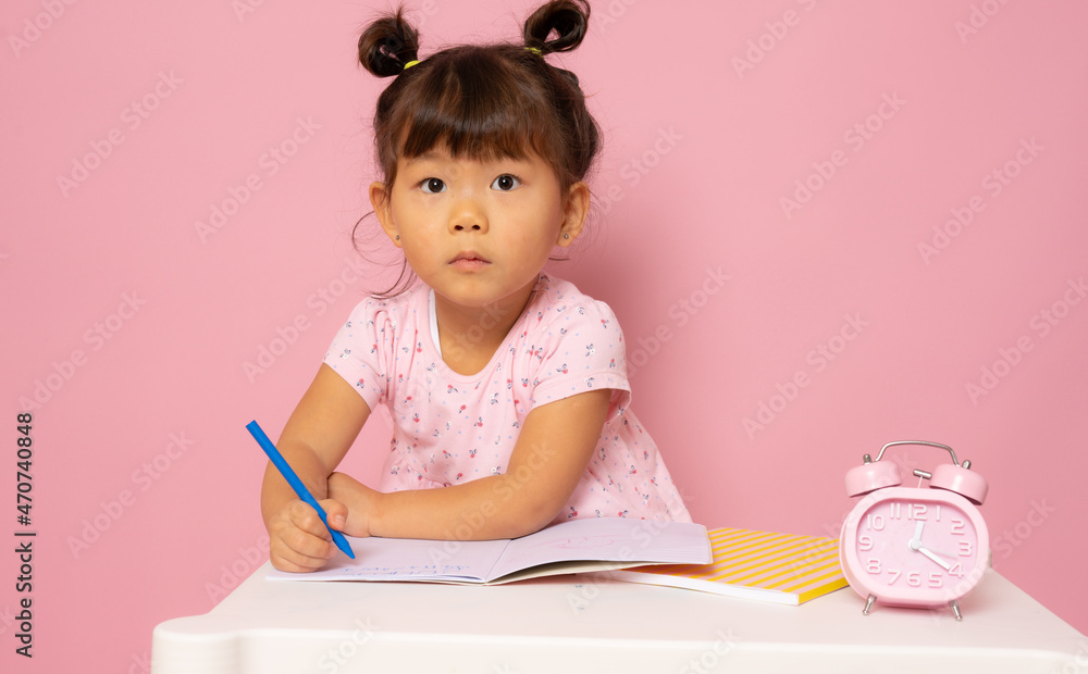Cute little asian girl with pencils isolated over pink background. Cute little asian girl with pencils isolated over pink background.