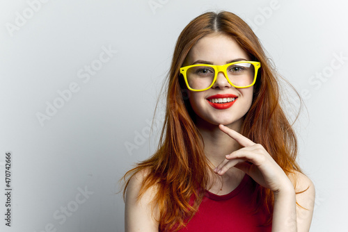 emotional woman in yellow glasses red lips attractive look