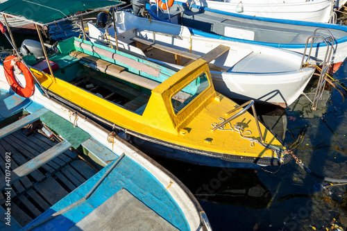 Wallpaper Mural Row of many small old wooden vintage colorful bright fishing ships moored at fisherman village marina clear water bay on bright sunny day. Sea harbor with traditional retro vessels background Torontodigital.ca