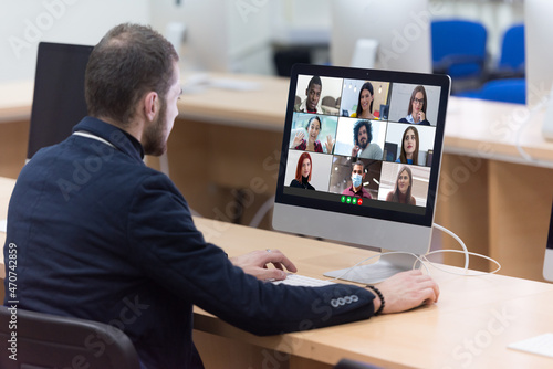 Multiethnic college students distance learning virtual remote class, group online interactive lesson on video conference call talking with professor via computer