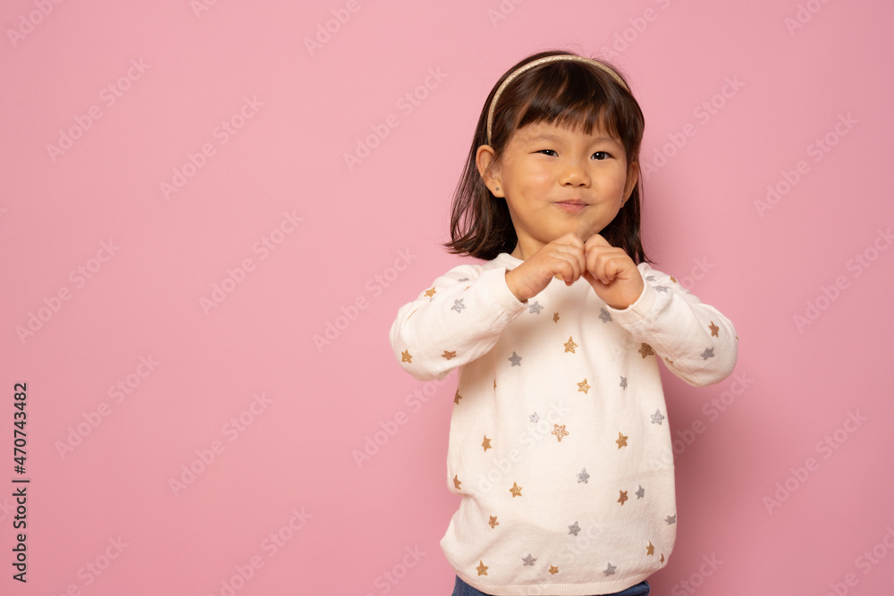 Portrait of beautiful little asian girl isolated over pink background. Portrait of beautiful little asian girl isolated over pink background.