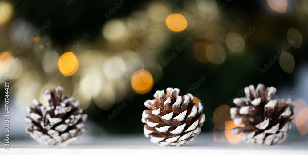 pine cones and Christmas lights holiday background