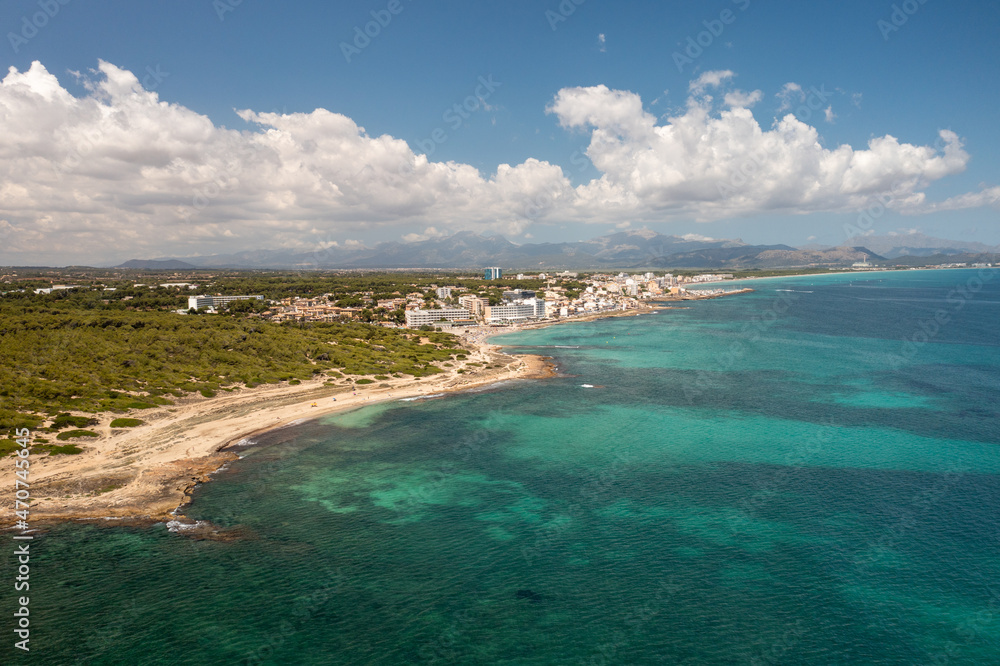Aerial drone photo taken on the beautiful island of Majorca in Spain showing the beach and sea front and sand dunes on a bright sunny summers day