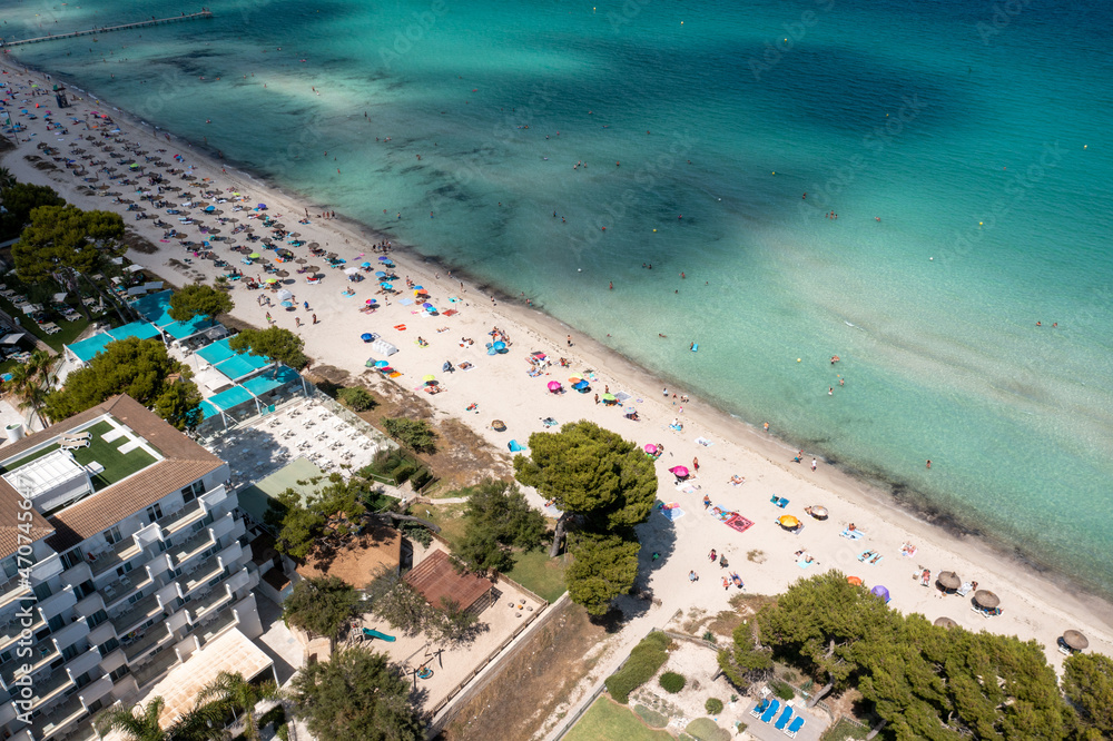 Aerial drone photo of the beach front on the Spanish island Majorca Mallorca, Spain showing the beach known as Platja de Muro in the village of Alcúdia on a sunny summers days