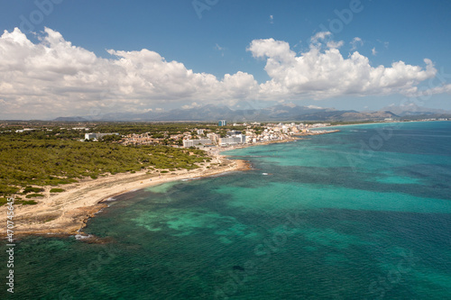 Aerial drone photo taken on the beautiful island of Majorca in Spain showing the beach and sea front and sand dunes on a bright sunny summers day