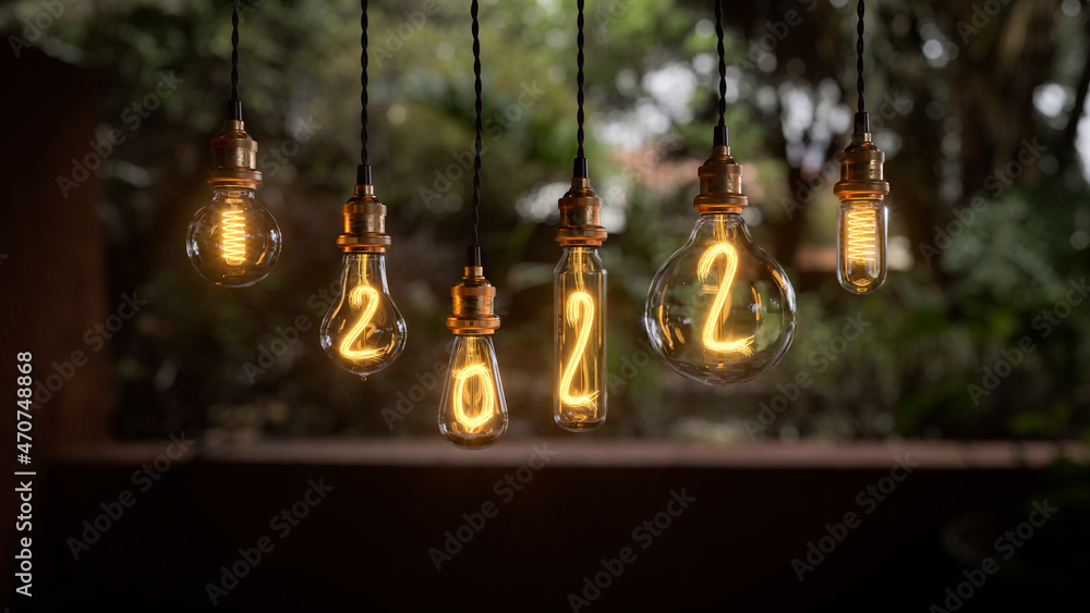 Obraz premium Light bulb New Year background. Edison light bulb. 2022 year. 3d rendering