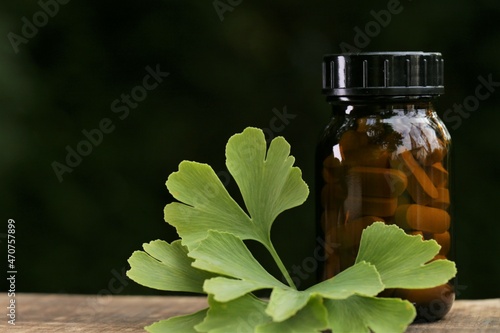 Ginkgo biloba tablets.Alternative medicine and homeopathy. Brown glass jar with pills ,ginkgo biloba leaves