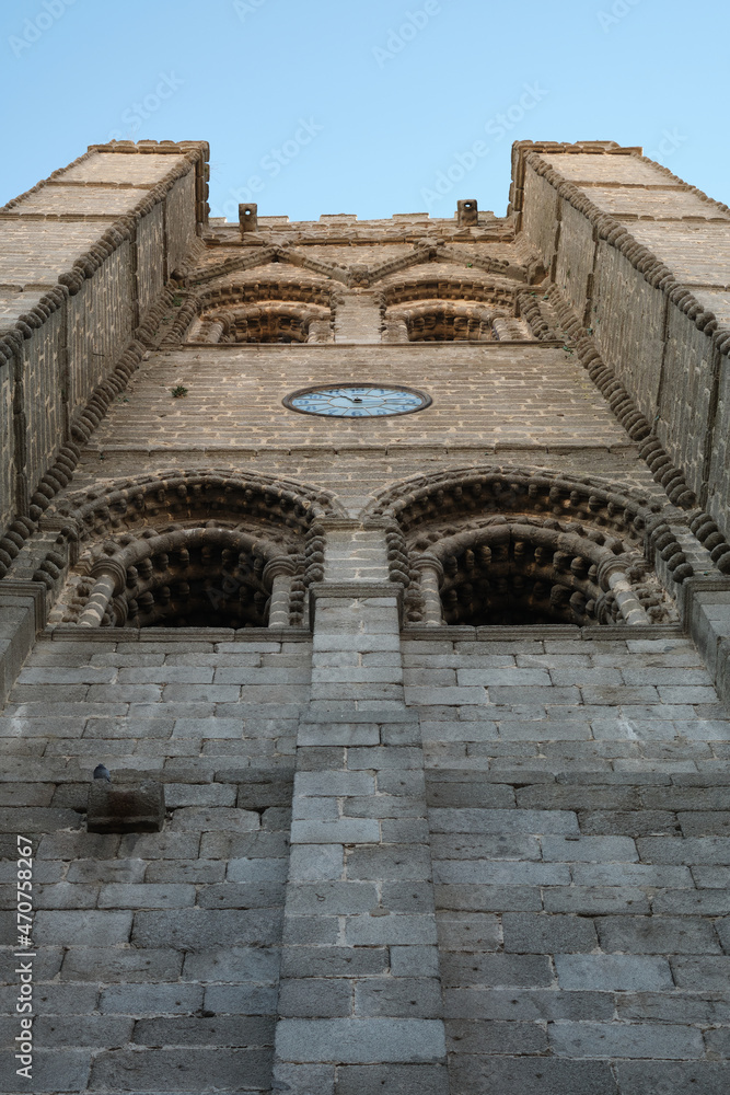 Low angle view of the tower of the Ávila Cathedral or Cathedral of the Saviour, a Catholic church in Ávila, Spain. It was built in the late Romanesque and Gothic architectural traditions.
