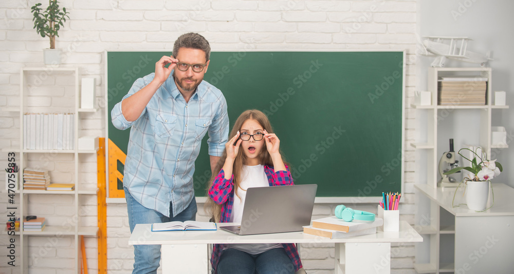 surprised teen girl and teacher man in high school with pc at blackboard, e-learning surprised teen girl and teacher man in high school with pc at blackboard, e-learning