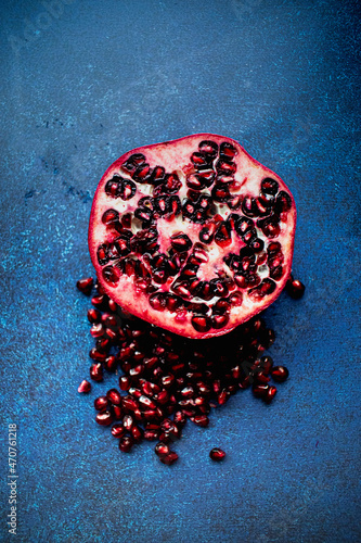 Half a pomegranate fruit, with seeds in view.