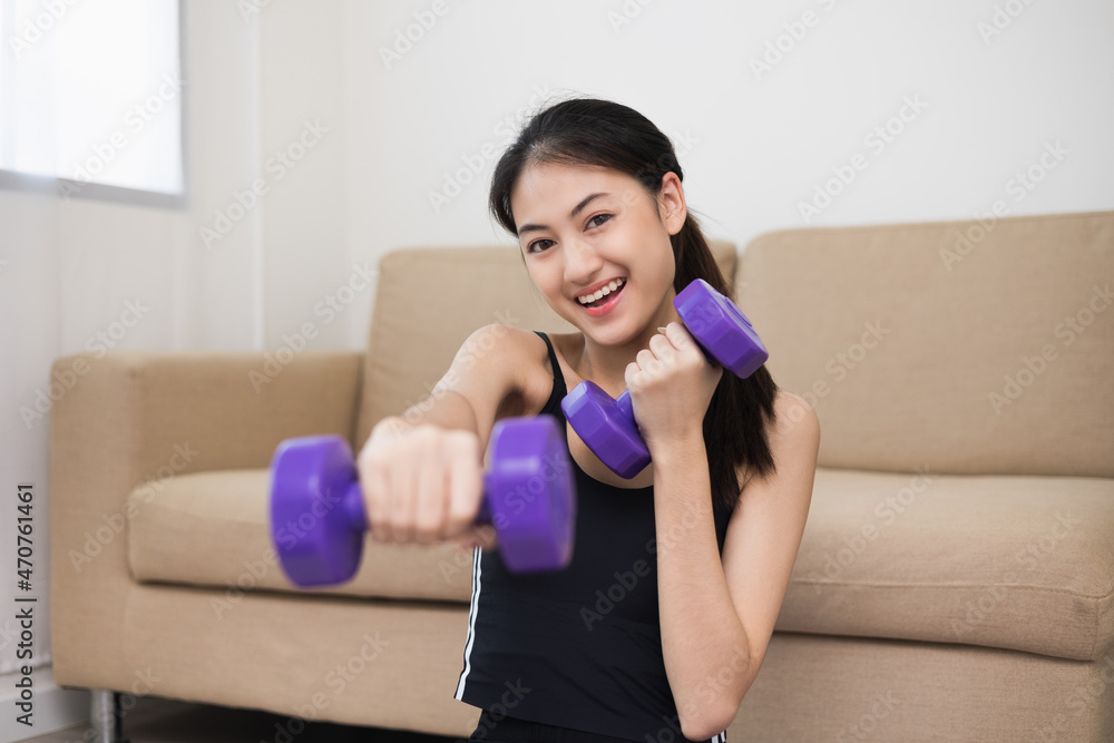 Attractive asian young fitness woman lifting dumbbell weights workout at home in living room. Fresh feeling female training and exercise wearing sport wear fit body. Attractive asian young fitness woman lifting dumbbell weights workout at home in living room. Fresh feeling female training and exercise wearing sport wear fit body.