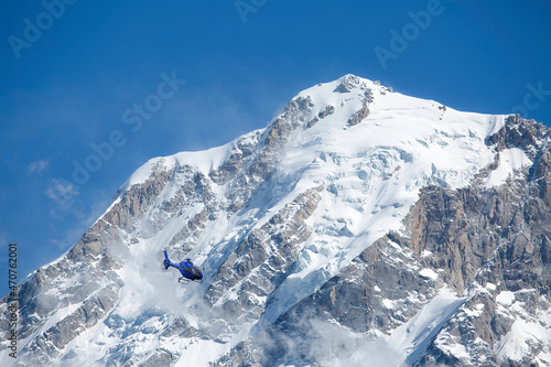 Helicopter used for tourist sightseeing flies past the Kailash Himalaya mountain range at Kalpa Himachal Pradesh, India