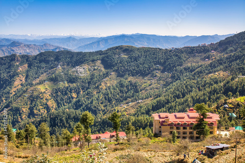 Scenic hill station aerial view with village houses on the mountain slopes with Himalaya landscape at Himachal Pradesh, India photo