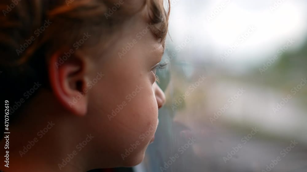 Child leaning on train window looking outside. Pensive toddler boy Child leaning on train window looking outside. Pensive toddler boy