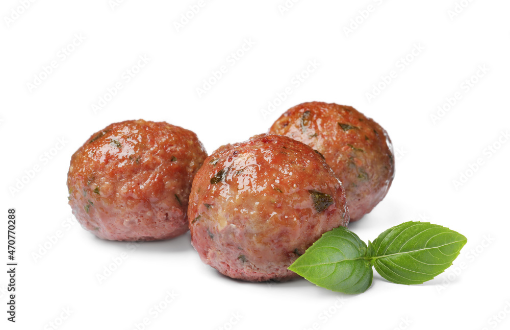 Many tasty cooked meatballs with basil on white background Many tasty cooked meatballs with basil on white background