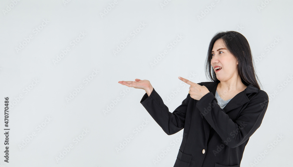 Surprised Asian businesswoman excited on incredible promotion notice by pointing fingers to blank space offered to attractive female executive for professional campaign.