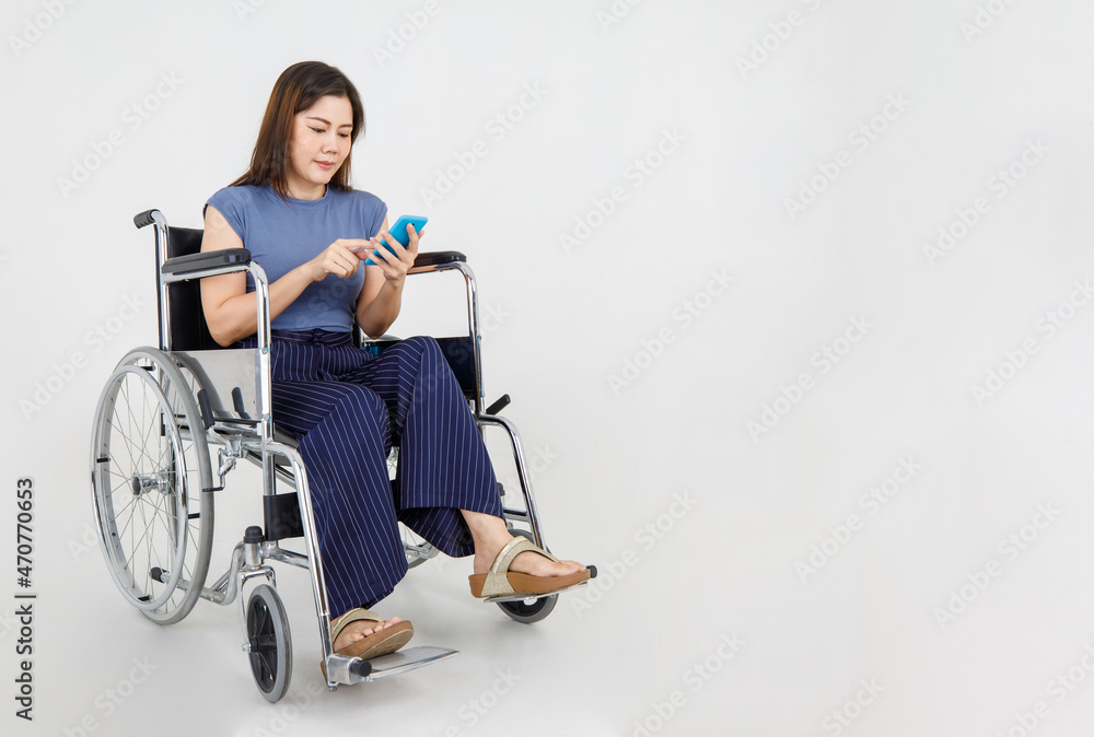 Injured female adult calling out by mobile phone while moving with medical wheelchair for disabled patient at hospital Injured female adult calling out by mobile phone while moving with medical wheelchair for disabled patient at hospital
